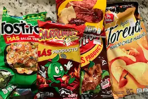 A selection of bagged snacks from Mexico: Tostitos Salsa Verde corn chips, Churrumais, Fritos, and Toreadas Sabor Chile Habanero