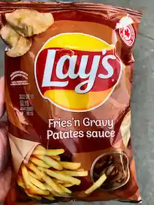 A bag of Lay's Fries'n Gravy flavored potato chips. The bag also contains the name in French: Patates sauce