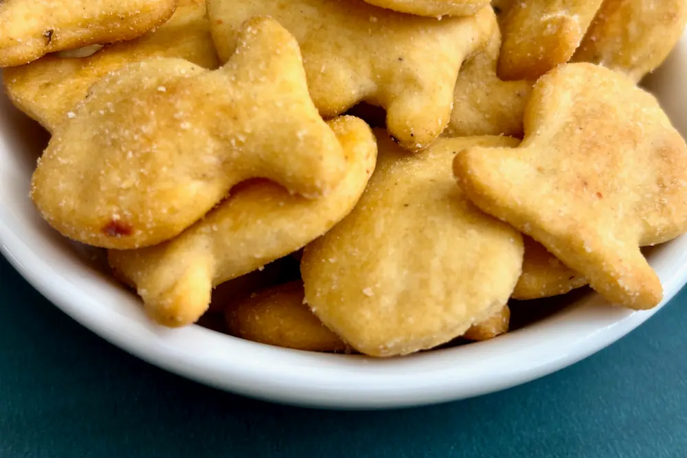 A close up view of Goldfish Mega Bites Cheddar Jalapeño flavored crackers in a bowl.